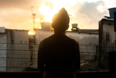 Person standing in front of the sun set