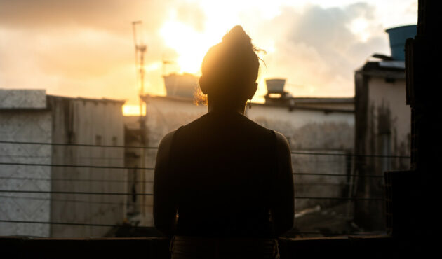 Person standing in front of the sun set