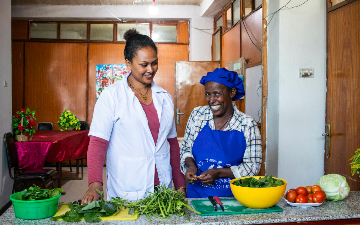 people preparing food and smiling